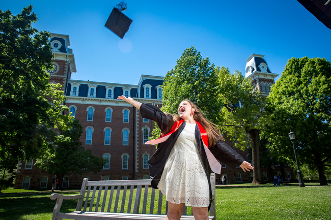 Excited graduate tossing mortar board